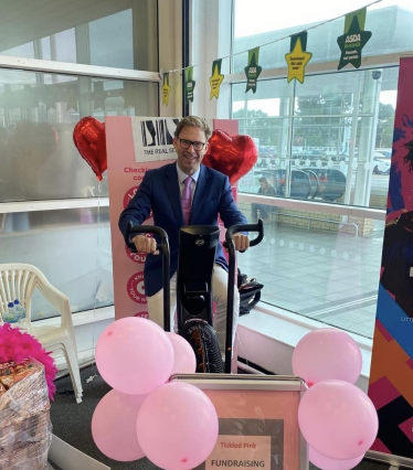 Tobias Ellwood MP riding bike for ASDA 'tickled in pink' fundraiser